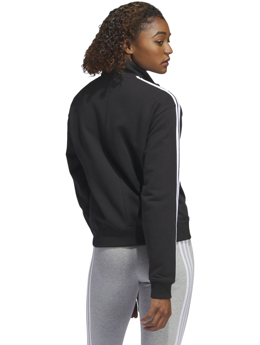Sudadera deportiva Adidas negra con rayas blancas laterales y cierre parcial en el cuello.
