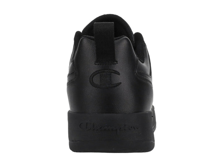 Tenis Champion color negro, diseño de corte bajo con suela gruesa y logo en el lateral.