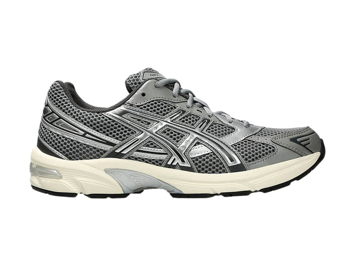 Tenis deportivos ASICS GEL-1130 en color gris y plata con suela blanca.