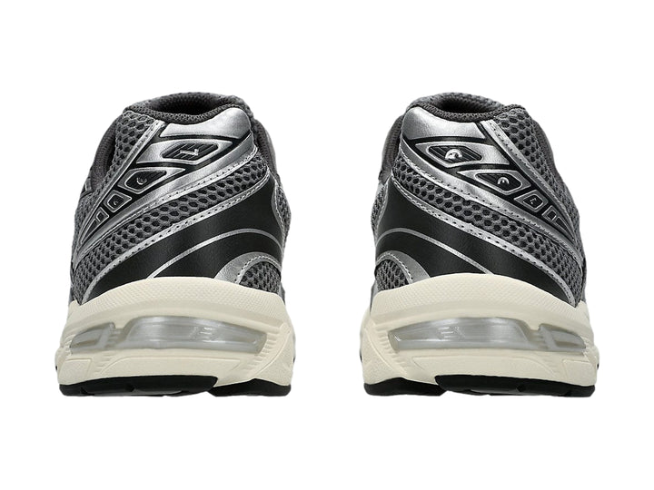 Tenis deportivos ASICS GEL-1130 en color gris y plata con suela blanca.