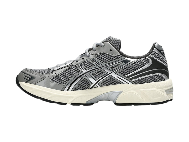 Tenis deportivos ASICS GEL-1130 en color gris y plata con suela blanca.
