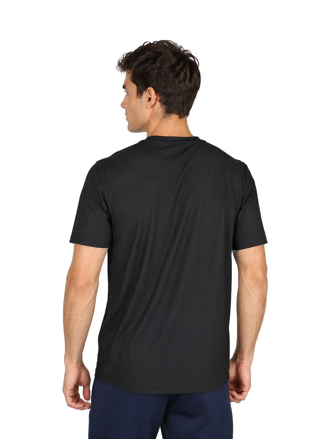Hombre vistiendo una playera negra de manga corta y cuello redondo con tecnolog�a dry fit.