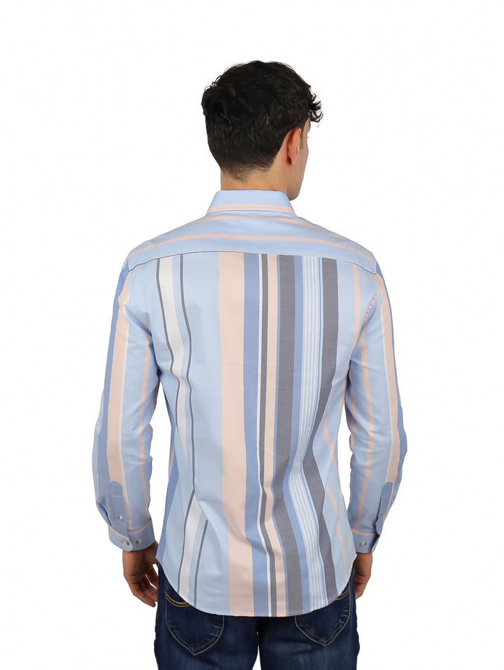 Hombre vistiendo una camisa azul con rayas verticales en tonos gris y rosa.