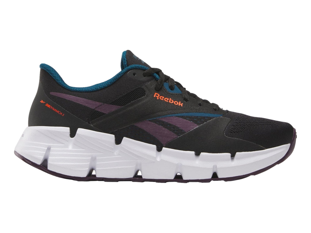 Tenis deportivos Reebok Zig Dynamica color negro con suela blanca y detalles en morado.