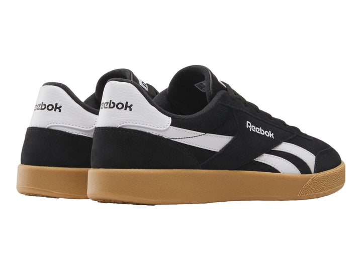 Tenis Reebok Smash Edge color negro con detalles blancos y suela de goma marrón.