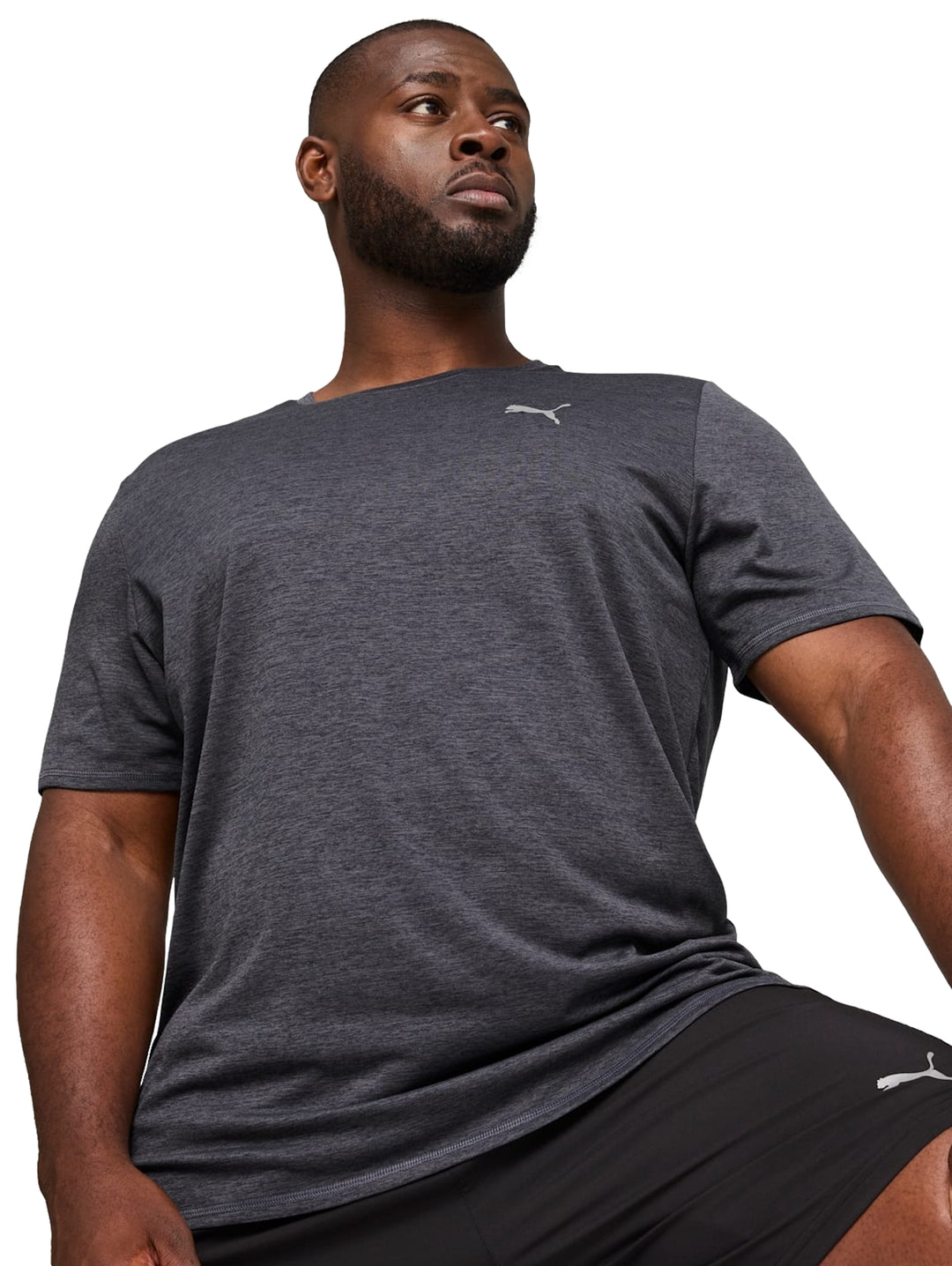 Hombre vistiendo camiseta deportiva PUMA de color gris galáctico jaspeado y manga corta.