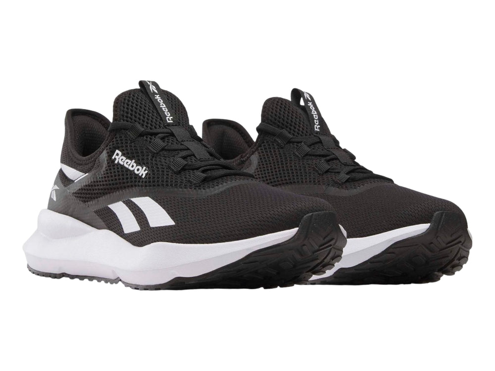 Tenis deportivos Reebok color negro con suela blanca y detalles laterales en blanco.