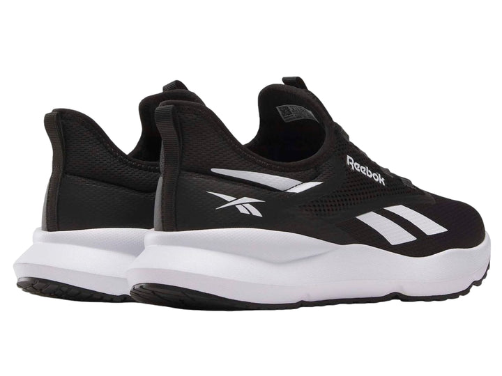 Tenis deportivos Reebok color negro con suela blanca y detalles laterales en blanco.