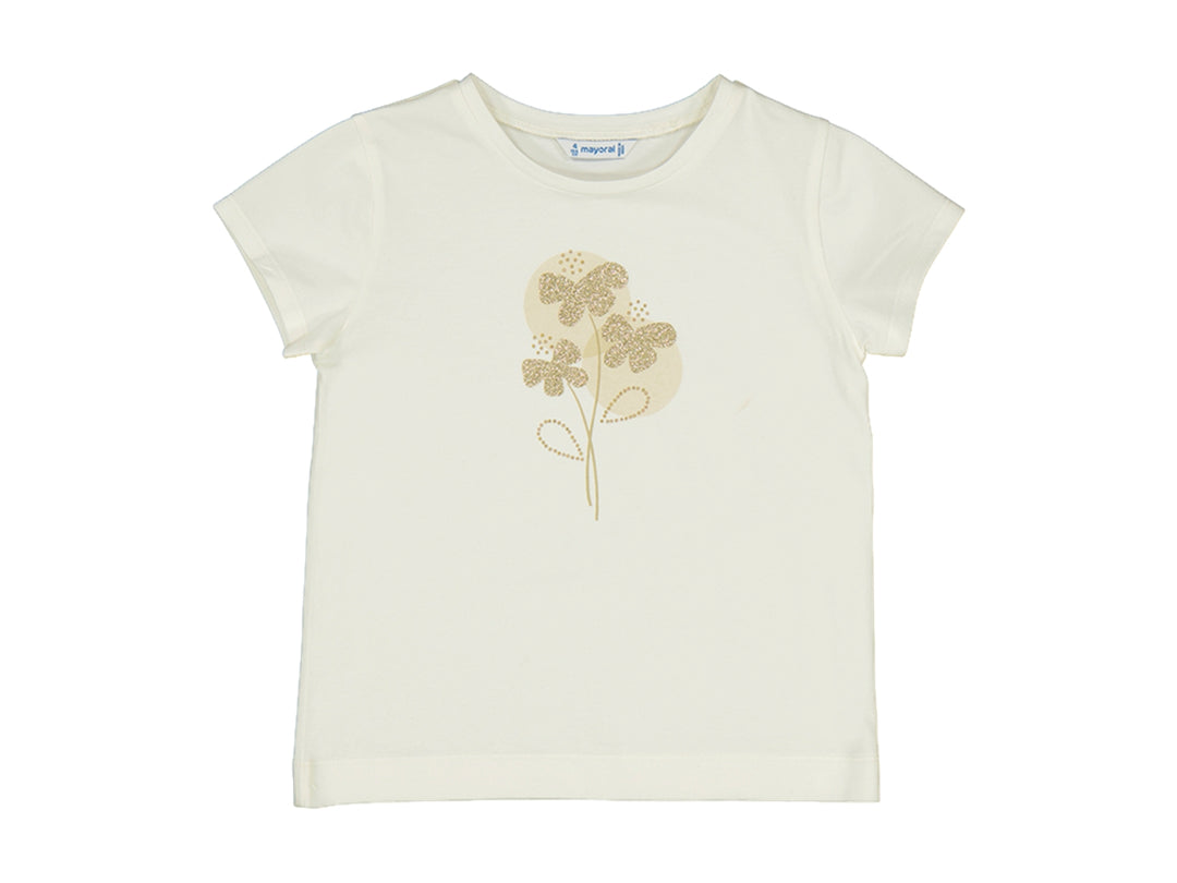 Camiseta color crudo para niños con diseño floral brillante en dorado en el centro.