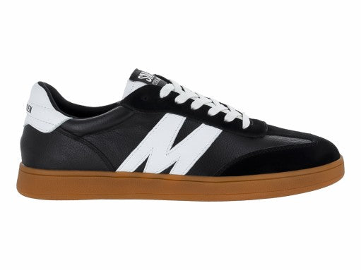 Tenis Steve Madden Caelum en color negro con detalles blancos y suela marrón caramelo.