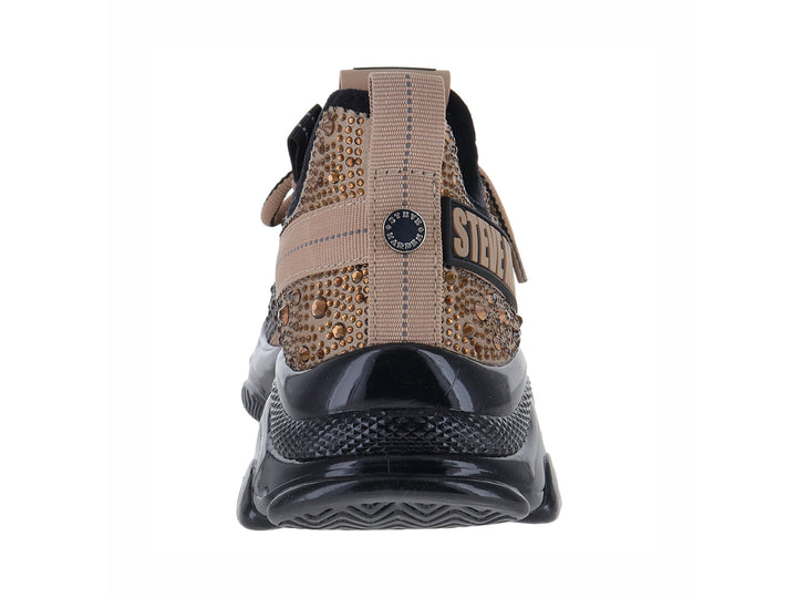 Tenis Steve Madden Mistic en color negro y dorado con suela chunky brillante.