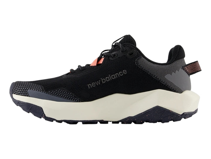 Tenis New Balance deportivos color negro con suela blanca y detalles en gris y naranja.