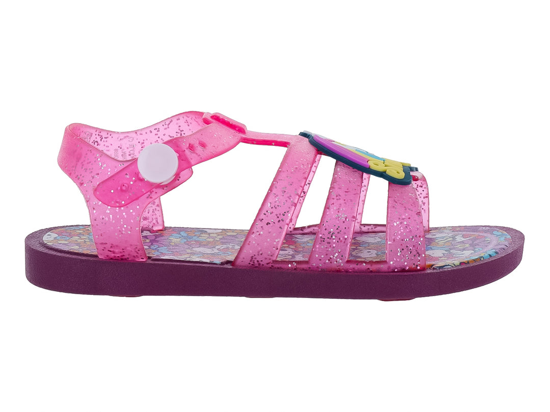 Sandalia infantil color rosa con glitter y suela morada.