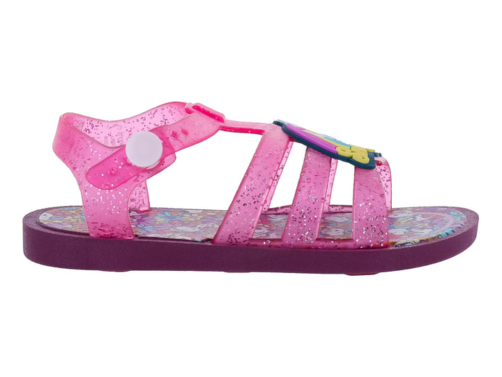 Sandalia infantil color rosa con glitter y suela morada.