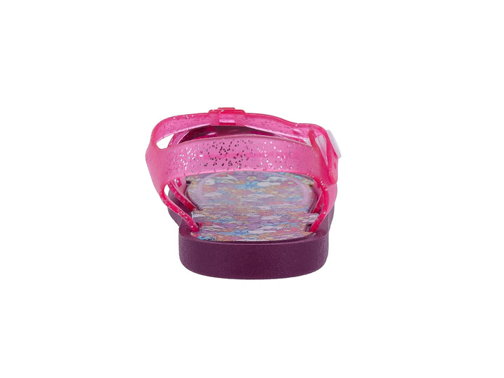 Sandalia infantil color rosa con glitter y suela morada.