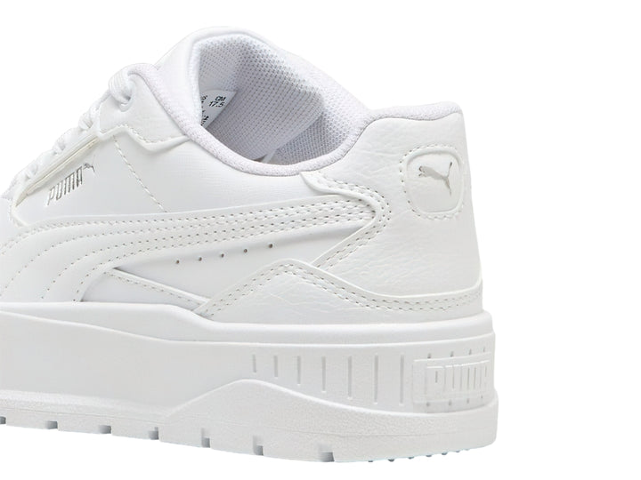 Tenis PUMA blancos con suela de plataforma gruesa para niños.