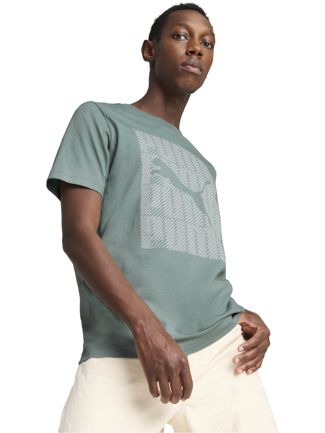 Hombre vistiendo camiseta PUMA color verde con gráfico frontal y pantalones color crema.