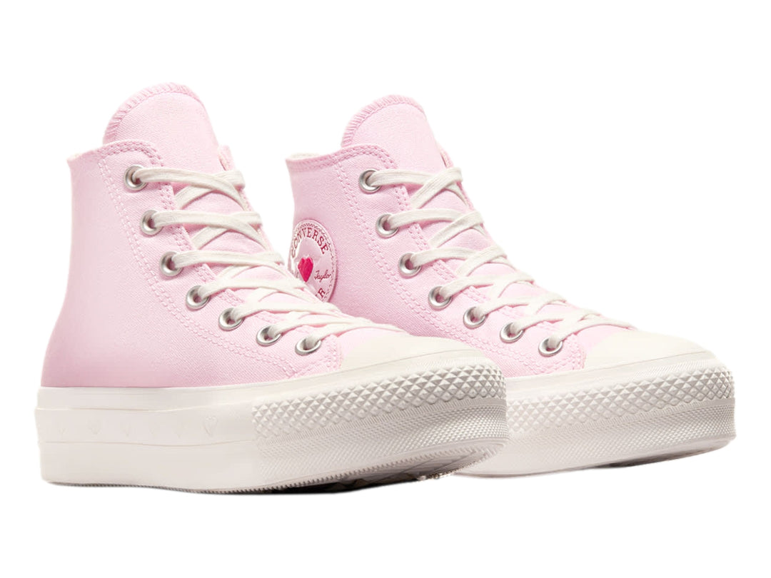 Tenis Converse botín color rosa con suela blanca y detalles decorativos.