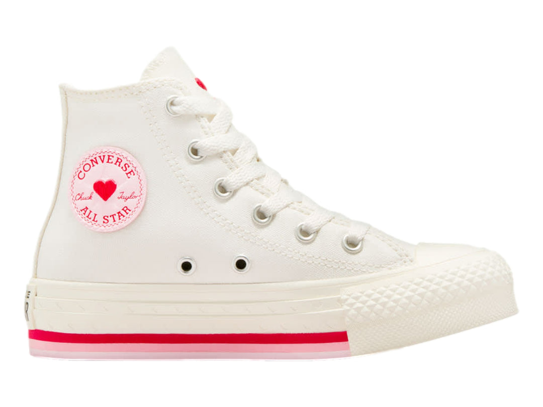 Tenis Converse blancos de bota alta con detalles en rojo y logo circular en el tobillo.