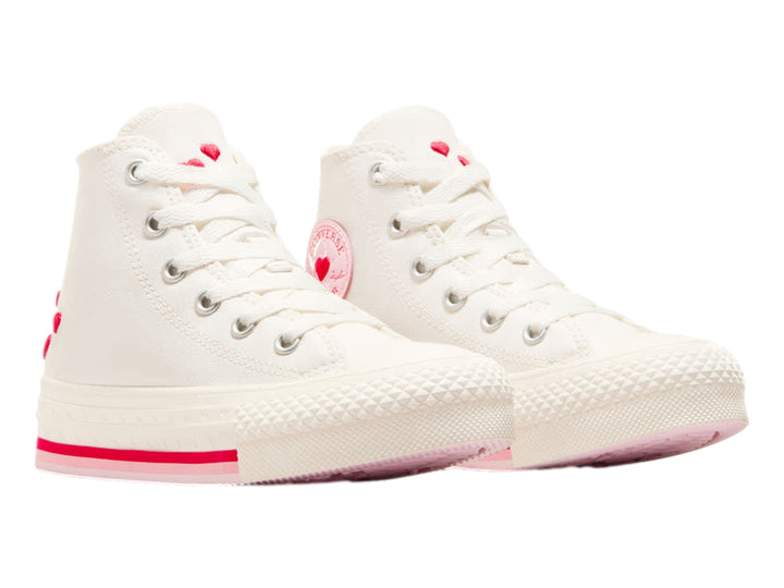 Tenis Converse blancos de bota alta con detalles en rojo y logo circular en el tobillo.