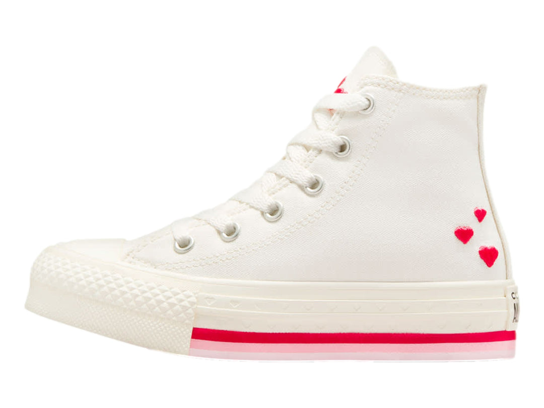 Tenis Converse blancos de bota alta con detalles en rojo y logo circular en el tobillo.