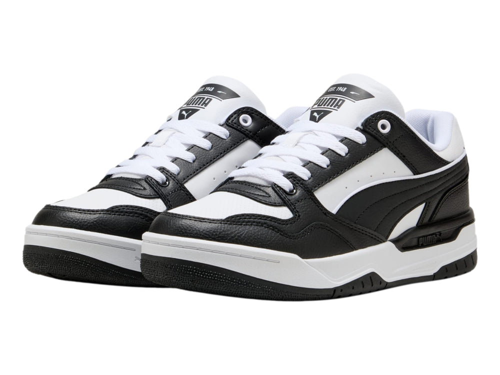 Tenis PUMA Rebound Retro en colores blanco y negro con suela blanca y detalles negros.