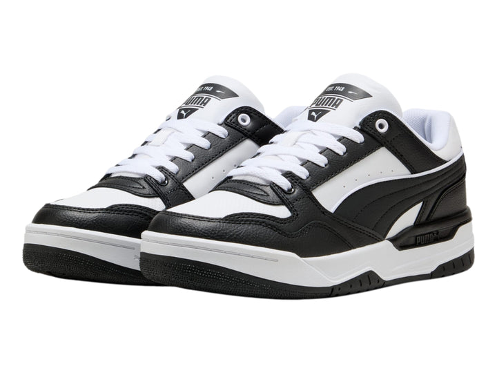 Tenis PUMA Rebound Retro en colores blanco y negro con suela blanca y detalles negros.