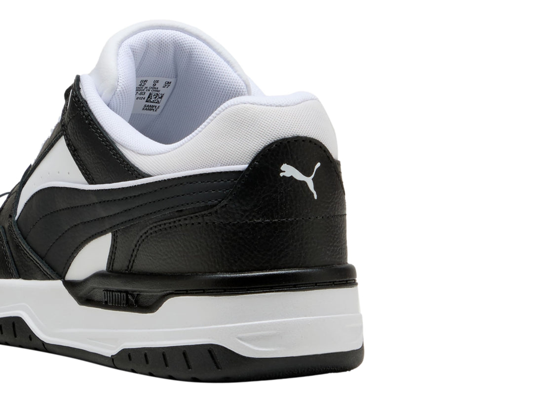 Tenis PUMA Rebound Retro en colores blanco y negro con suela blanca y detalles negros.