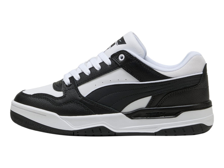 Tenis PUMA Rebound Retro en colores blanco y negro con suela blanca y detalles negros.