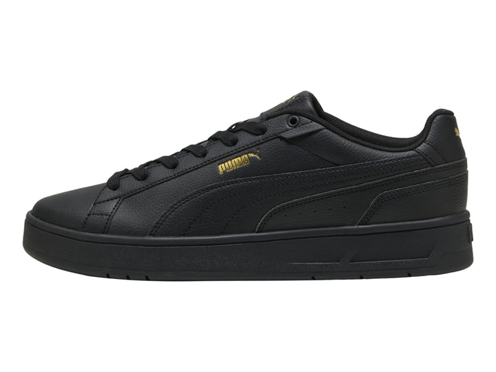 Tenis PUMA Court Classico color negro con suela plana y textura de cuero.