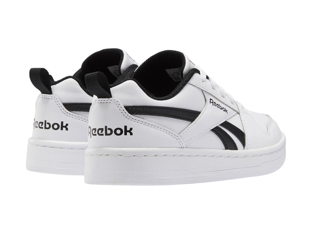 Tenis Reebok blancos con detalles en negro, diseño deportivo de corte bajo para niños.