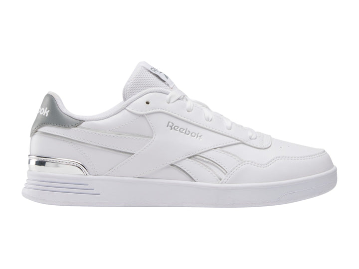 Tenis Reebok blancos de corte bajo con detalles plateados y suela blanca.