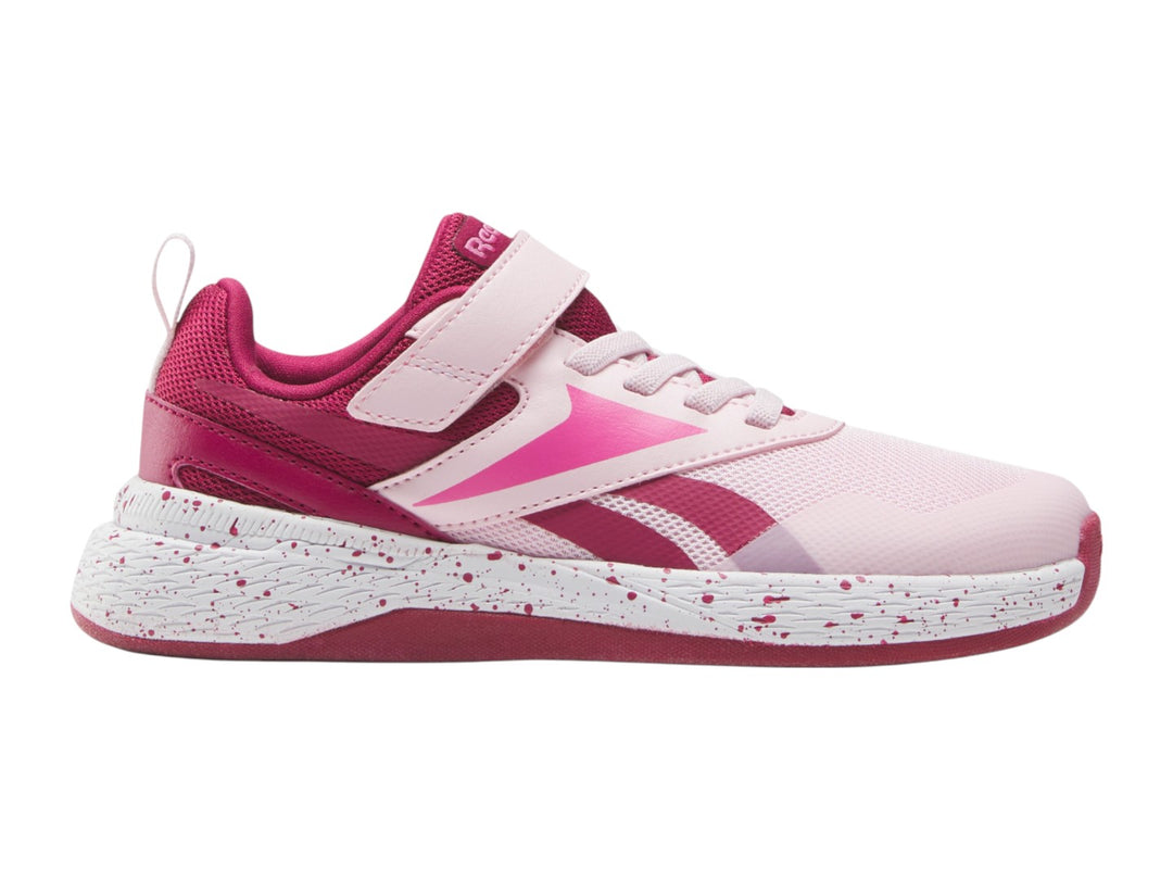 Tenis deportivos Reebok color rosa con suela blanca moteada y correa superior para Niña.