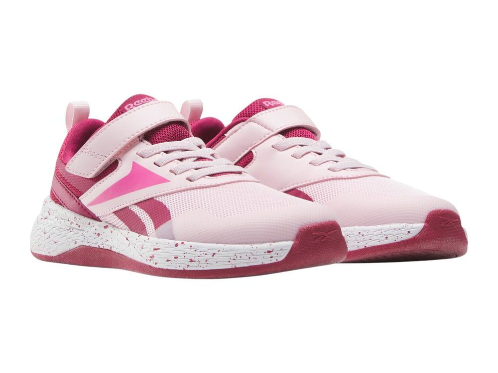 Tenis deportivos Reebok color rosa con suela blanca moteada y correa superior para Niña.