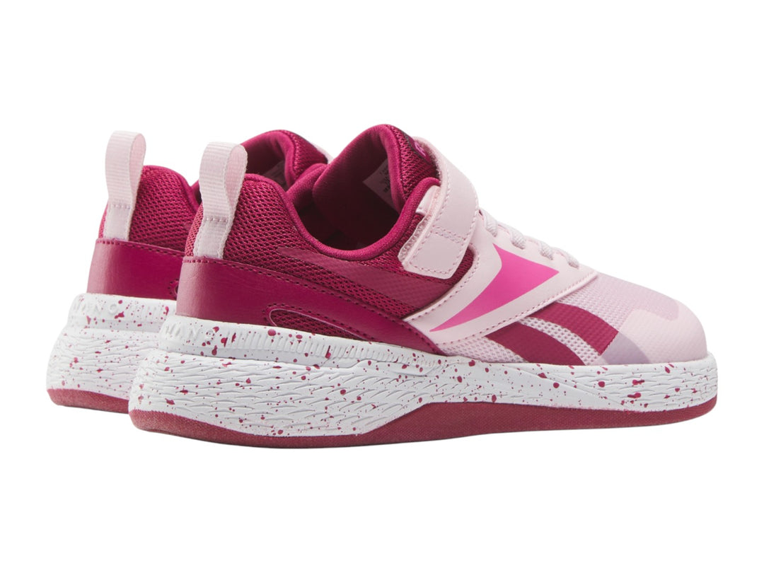 Tenis deportivos Reebok color rosa con suela blanca moteada y correa superior para Niña.