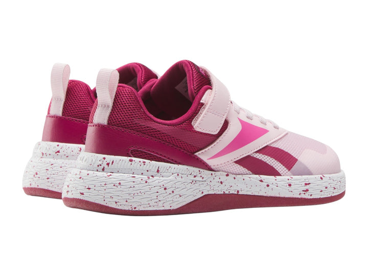 Tenis deportivos Reebok color rosa con suela blanca moteada y correa superior para Niña.