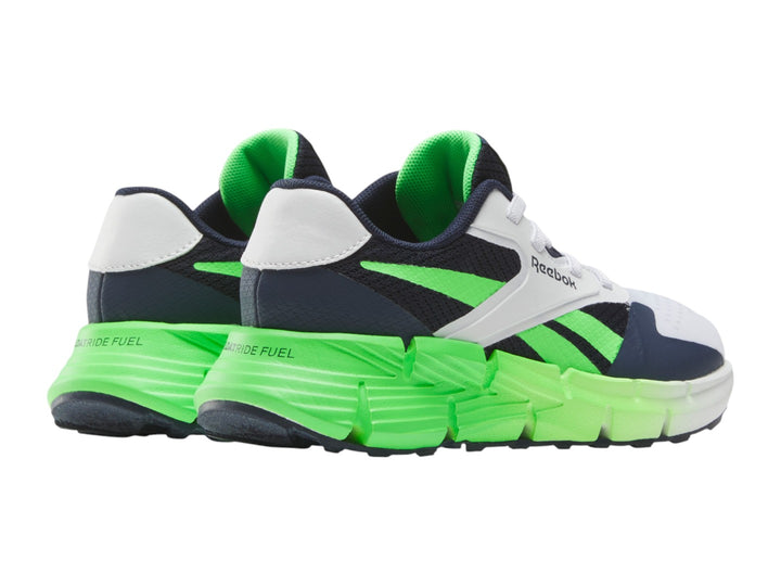 Tenis deportivos Reebok blancos con detalles en azul marino y suela verde neón.