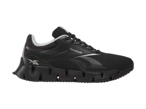 Tenis deportivos Reebok Zig Dynamica en color negro con detalles blancos y suela amortiguada.