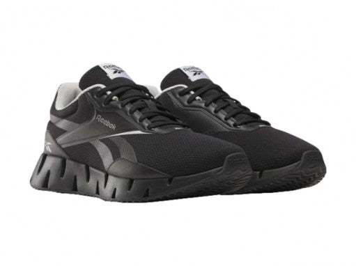 Tenis deportivos Reebok Zig Dynamica en color negro con detalles blancos y suela amortiguada.