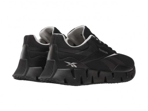 Tenis deportivos Reebok Zig Dynamica en color negro con detalles blancos y suela amortiguada.