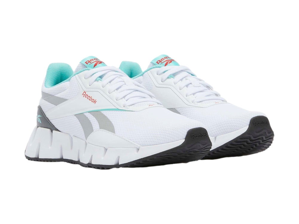 Tenis deportivos Reebok Zig Dynamica en color blanco con detalles en gris y turquesa.