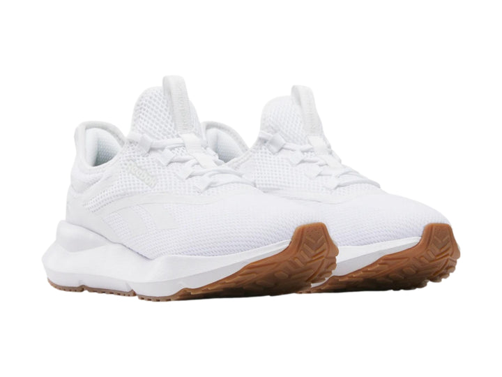 Tenis deportivos Reebok color blanco con suela color café.
