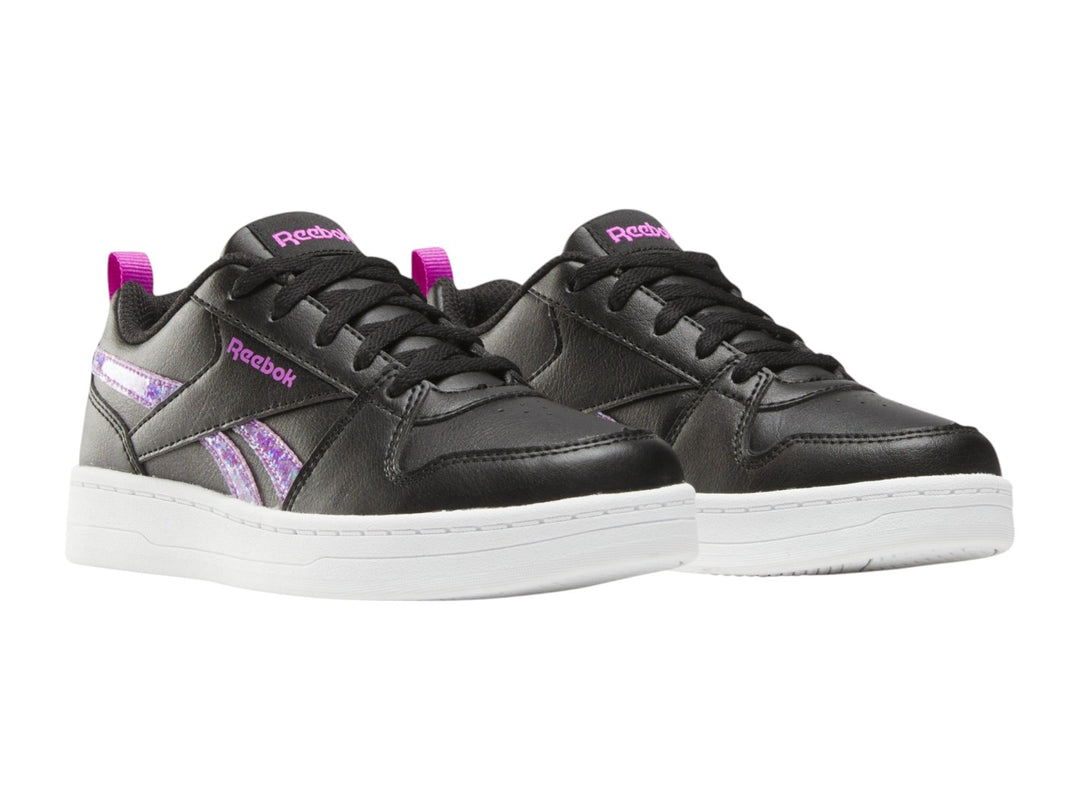 Tenis Reebok negros con suela blanca y detalles laterales en morado brillante.
