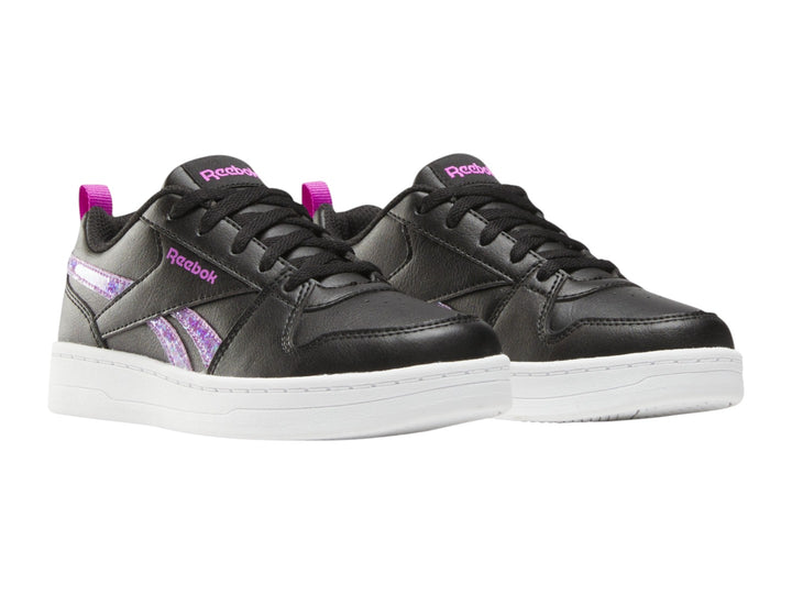Tenis Reebok negros con suela blanca y detalles laterales en morado brillante.