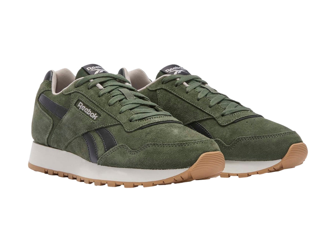 Tenis deportivos Reebok color verde oliva con detalles en negro y suela blanca y café.