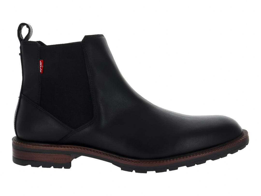 Bota estilo Chelsea color negro con suela marrón y panel elástico lateral.