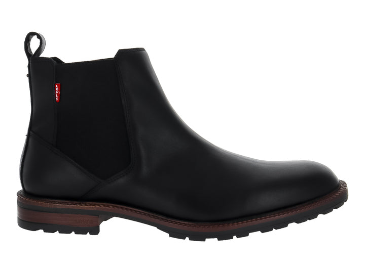 Bota estilo Chelsea color negro con suela marrón y panel elástico lateral.