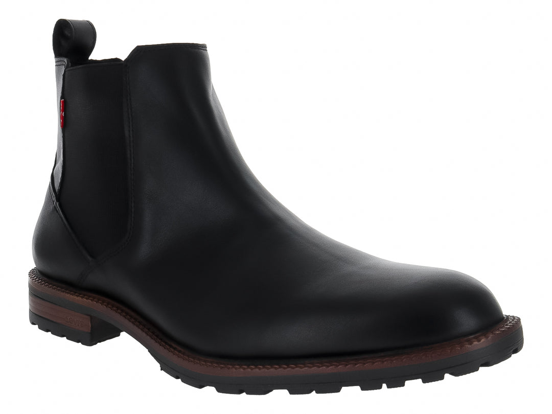 Bota estilo Chelsea color negro con suela marrón y panel elástico lateral.