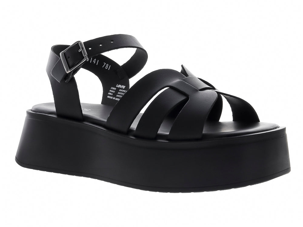 Sandalia de plataforma color negro con correas frontales y hebilla ajustable en el tobillo.