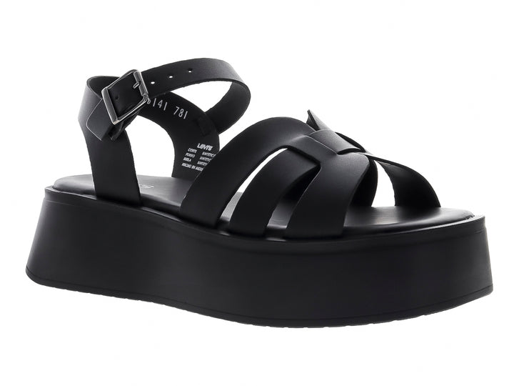 Sandalia de plataforma color negro con correas frontales y hebilla ajustable en el tobillo.